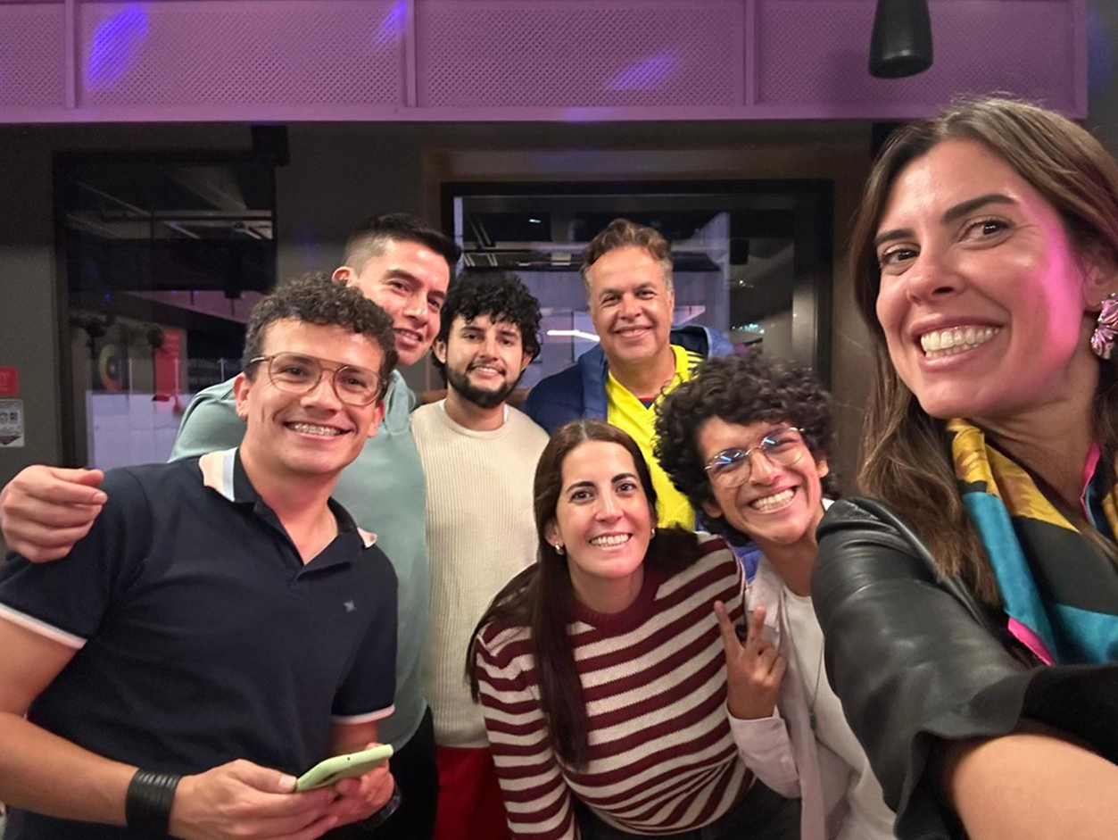 Smiling Valtech team members taking a group selfie in a casual, vibrant setting, showcasing workplace camaraderie and company culture.