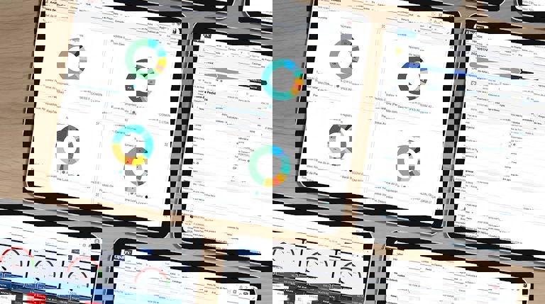 Image with multiple tablets featuring various charts and graphs